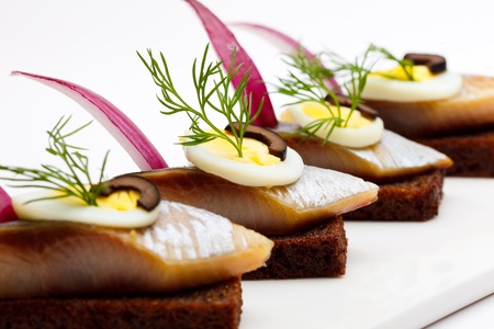 canape , menyu. bread,olive,herring,egg,cucumber,lemon,greens,saucerの写真素材