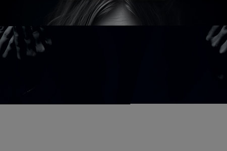 Captivating Mystery: A Photo Girl Playfully Hiding Her Face Behind Hands, Peeking Through One Eye -の素材