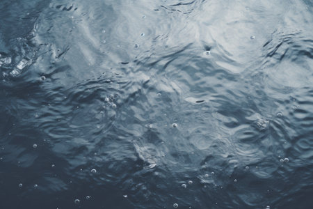 Capturing the Serene Beauty of Rippling Waters: Close-Up Photo on a Grey Surfaceの素材
