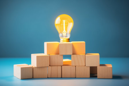 Shining Ideas: Unlocking the Power of Innovation and Solution with Wooden Cubes and Yellow Light Bulの素材