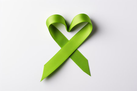 Environmental Consciousness Emblem: Handcrafted Green Ribbon Symbolizing Awareness on White Backgrouの素材