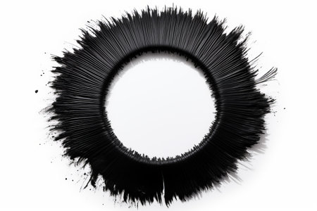 Black Mascara Unveiled: A Close-up of Circular Texture and Brush Stroke on a White Backgroundの素材
