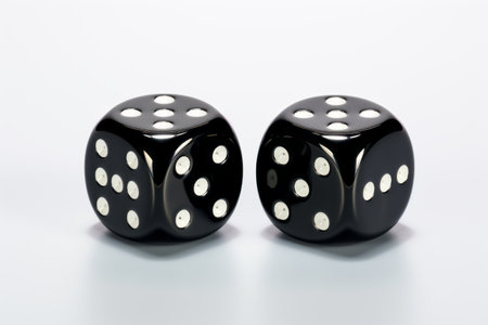 Rolling the Odds: Two Black Glass Dice Unveil a Five and Two on a White Canvasの素材