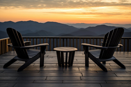Serene Sunset Scenery: Unwinding on the Terrace, Gazing at Majestic Mountains from Elegant Black Wooden Chairsの素材