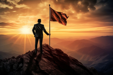 Reaching New Heights: The Resilient Businessman Defying Sunrise on the Mountain Topの素材