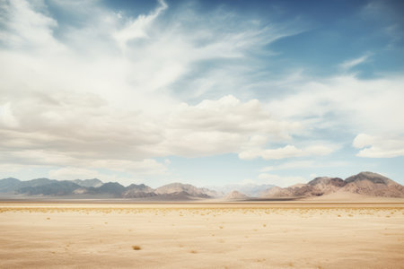 Majestic Snow-Capped Horizons: Desert Meets the Enchanting Snowy Peaks Amidst a Cloudy Skyの素材