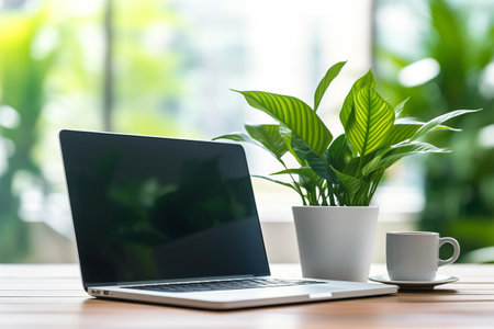 Productivity Boosting Essentials: Workspace Laptop, Coffee Cup, and a Touch of Greeneryの素材