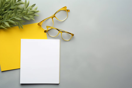 Tech Essentials: Vibrant Plant, Keyboard, Mouse, Glasses, and More Frame the Gray Background with Room to Spare [AR 3:2]の素材