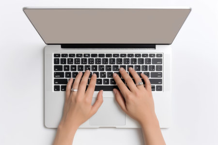 Efficient and Skilled: Female Hands Mastering a Modern Laptop in a Clean Office Settingの素材