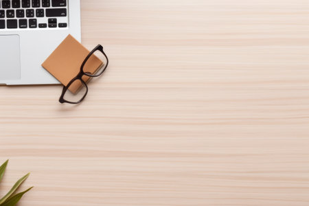 Modern minimalist home office setup: Wood desk with laptop, stationery, and stylish decor in flat lay compositionの素材