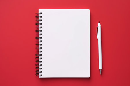 Back to School: Notebook and Pen on Vibrant Red Background - A Dynamic Top-View Setting with Flat Lay Perspectiveの素材