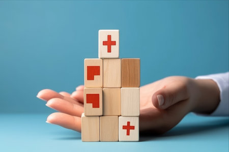The Power of Choice: Symbolic Hand Selects Healthcare Cube on Blue Background, Emphasizing Health Insurance Conceptの素材