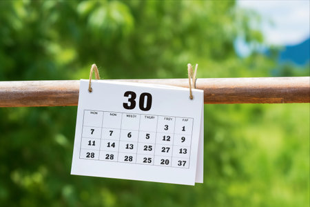 Vintage Wood Calendar: A White Wooden Calendar Set Against an Abstract Background, Perfect for a Summer Day with Ample Copyspace for Your Text - June 30thの素材