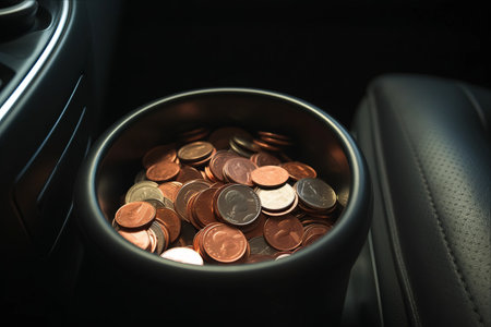 Capturing the Charm of Everyday Discoveries: A Close-Up of Pennies in a Jakarta Car Armrest - Perfect for Illustrating Life's Beautiful Trivialitiesの素材