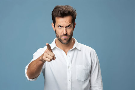 The Self-Important Success: A Closeup of an Arrogant Man in a White Shirt Pointing at Himselfの素材