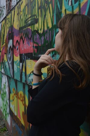 Young woman beside muralの写真素材