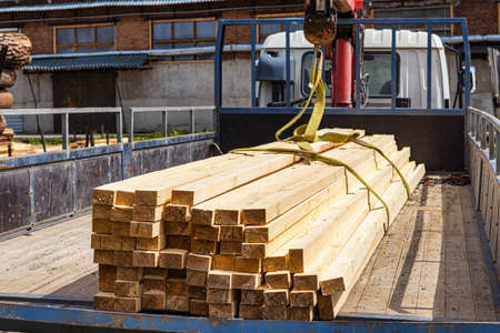 Transportation of lumber by car. Self-loading at the wood warehouse, delivery to the client.の写真素材