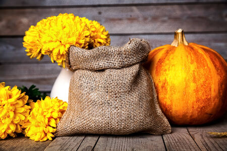 Flowers. Beautiful yellow chrysanthemum in vintage pottery vase. Old wooden backgroundの写真素材