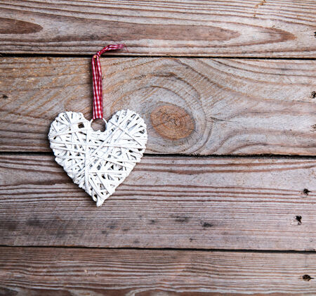 White heart on a wooden background. Red, Valentine's Day, Day of the enamoredの写真素材