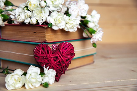 gentle carnation in the old book on a wooden background. Valentine's Dayの写真素材