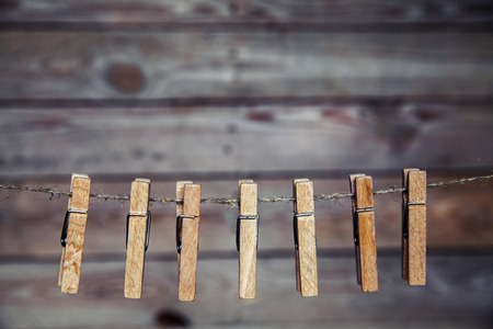 wooden clothespins on a ropeの写真素材
