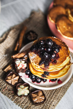 Picture of few pancakes with blackberries and sugar on wooden backgroundの写真素材