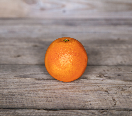 fresh, orange on  a wooden backgroundの写真素材