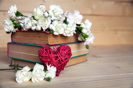 gentle carnation in the old book on a wooden background. Valentine's Dayの写真素材