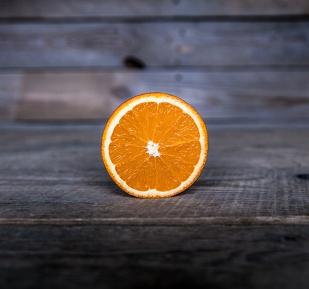 sliced orange on a wooden backgroundの写真素材