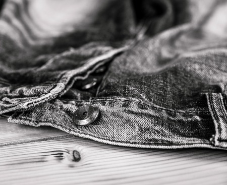Clothing. jeans and a button in the foregroundの写真素材