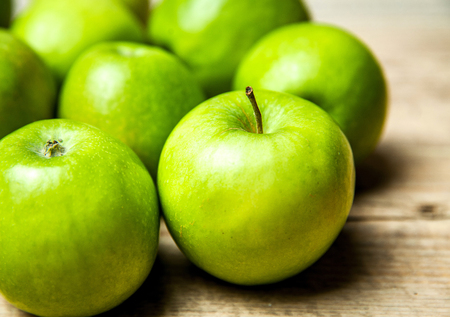 green apples on wooden backgroundの写真素材