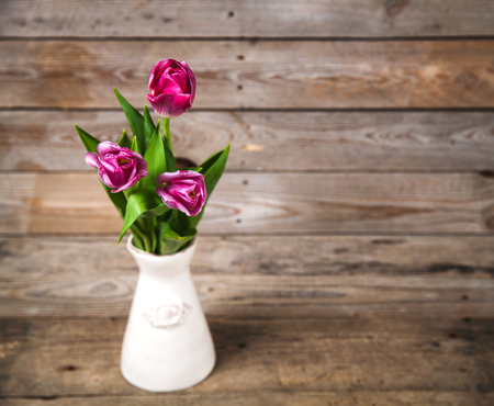Vase of natural tulips. flowers on a wooden backgroundの写真素材