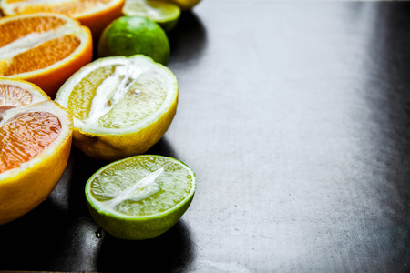 sliced citrus fruit on a black background. food