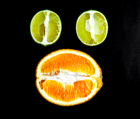 sliced citrus fruit on a black background. foodの写真素材