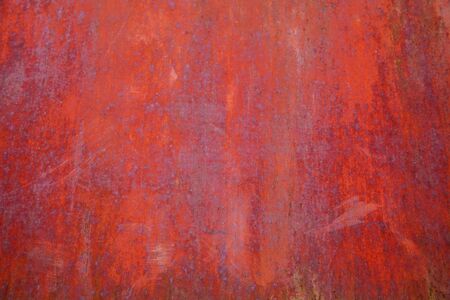 Background of old metal painted red with traces of rust and paintの写真素材