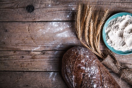 composition of bread, flour and ears on wooden backgroundの写真素材