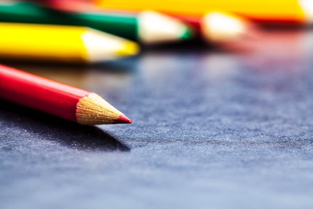 Colour pencils isolated on black background close upの写真素材