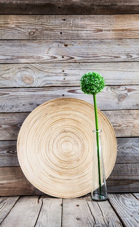 beautiful vase on abeautiful vase on a wooden plate with a flower on a wooden background wooden plate with a flower on a wooden backgroundの写真素材