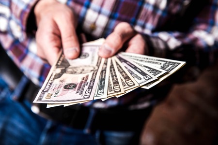 dollars in the handsの写真素材