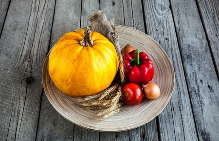 Sheaf on beige plate and wooden backgroundの写真素材