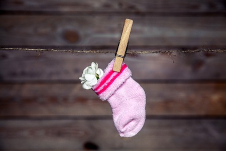 pink socks with cloves on clothespin