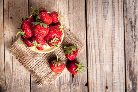 fruit. Fresh strawberries on old wooden backgroundの写真素材