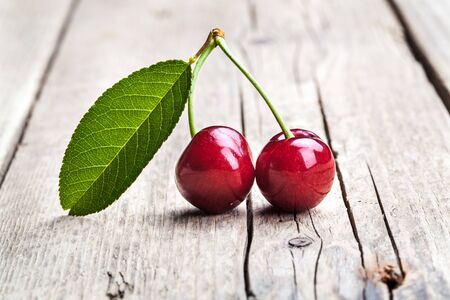 Cherry isolated on wooden background, fruits, berries