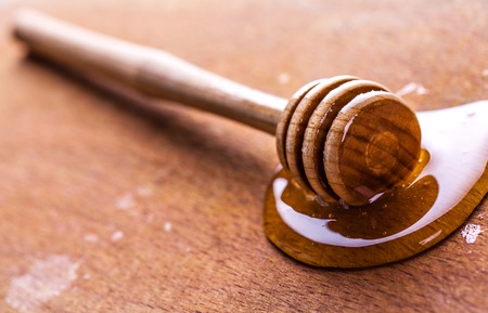 stick to honey on the wooden backgroundの写真素材