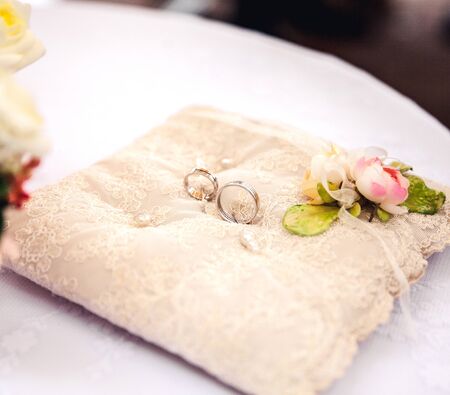 Wedding rings on a pillowの写真素材