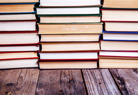 Old and used hardback books or text books seen from above. Books and reading are essential for self improvement, gaining knowledge and success in our careers, business and personal livesの写真素材