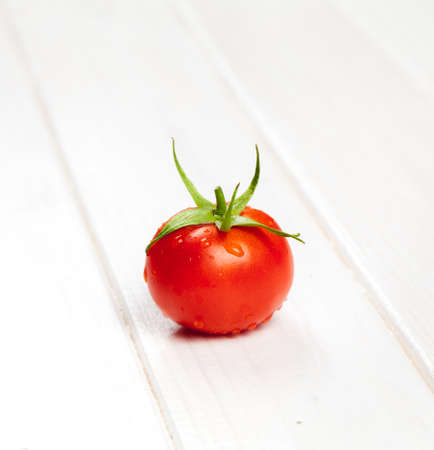 red tomatoes on wooden tableの写真素材