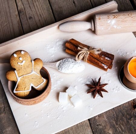 Christmas baking cookies with baubles  spices and empty cutting board abstract backgroundの写真素材