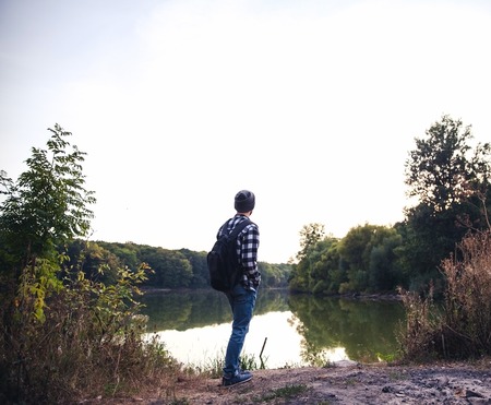 Young Man standing alone outdoorの写真素材