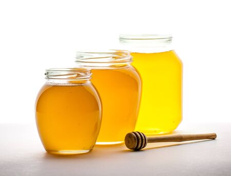 jars of honey on a white background. food, medicineの写真素材